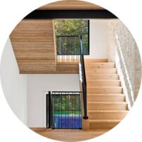 STEP UP This staircase is flanked with custom powder-coated steel railings from Honan’s Custom Metal.