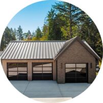 SPACE FOR EVERYTHING The garage doors were installed by Rainier Pacific Garage Doors. The brick is Pacific Clay Modular Smooth in Charcoal.